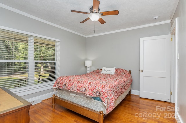 304 W Colonial Dr, Salisbury, NC 28144 - bedroom with wood finished floors, ornamental molding, a textured ceiling, and ceiling fan