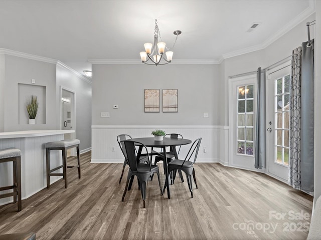 409 Danielle Way, Fort Mill, SC 29715 - dining area featuring ornamental molding, a chandelier, wood finished floors, and wainscoting
