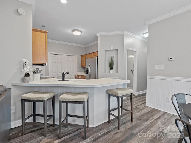 409 Danielle Way, Fort Mill, SC 29715 - kitchen with stainless steel refrigerator with ice dispenser, dark wood-style flooring, a kitchen bar, a peninsula, and light countertops