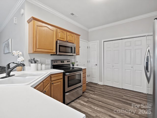 409 Danielle Way, Fort Mill, SC 29715 - kitchen with stainless steel appliances, crown molding, dark wood-type flooring, and light countertops