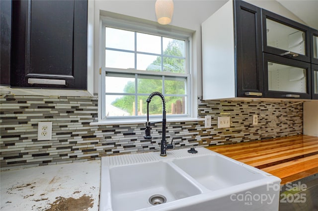 1312 Shenandoah Cir, Rock Hill, SC 29730 - kitchen with decorative backsplash, light countertops, glass insert cabinets, and dark cabinets