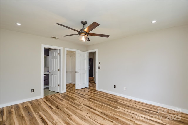 1312 Shenandoah Cir, Rock Hill, SC 29730 - unfurnished bedroom with light wood-style floors, a walk in closet, recessed lighting, a ceiling fan, and a closet