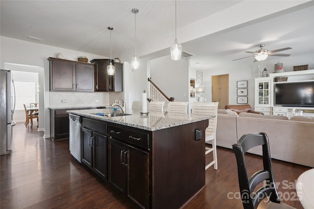 212 Fesperman Cir, Troutman, NC 28166 - kitchen with a breakfast bar area, stainless steel appliances, ceiling fan, tasteful backsplash, and light stone countertops