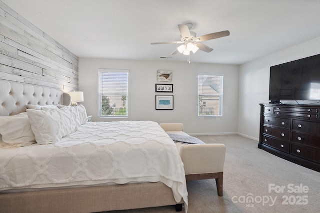 212 Fesperman Cir, Troutman, NC 28166 - carpeted bedroom featuring multiple windows, wooden walls, and ceiling fan