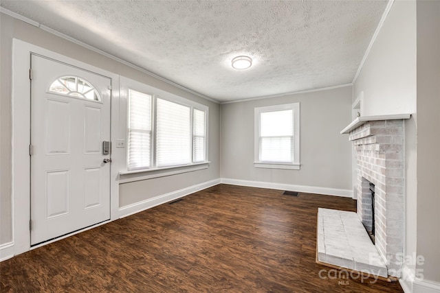 903 Rhode Island Ave, Kannapolis, NC 28083 - foyer featuring a fireplace, a textured ceiling, crown molding, and wood finished floors