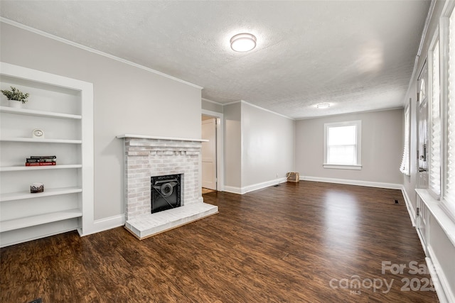 903 Rhode Island Ave, Kannapolis, NC 28083 - unfurnished living room featuring a textured ceiling, wood finished floors, crown molding, a brick fireplace, and built in features