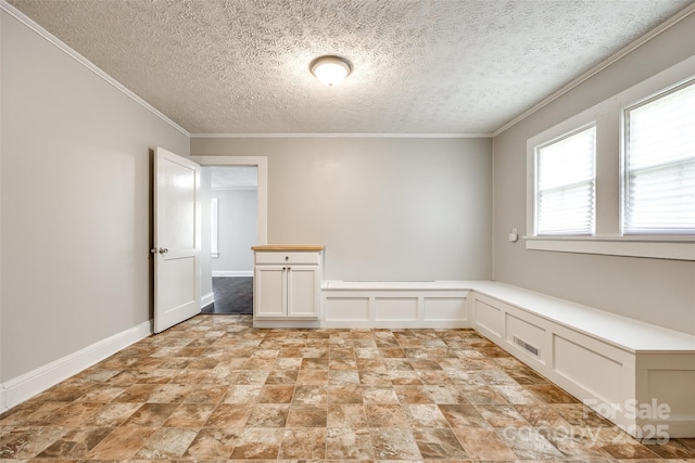 903 Rhode Island Ave, Kannapolis, NC 28083 - empty room with a decorative wall, crown molding, stone finish flooring, a textured ceiling, and a wainscoted wall