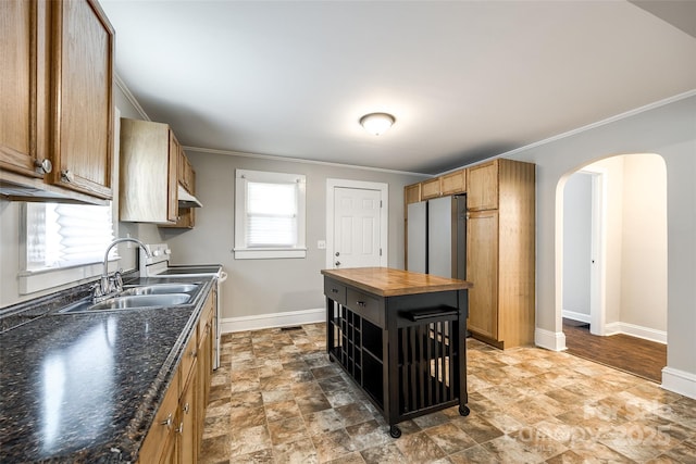 903 Rhode Island Ave, Kannapolis, NC 28083 - kitchen with wooden counters, arched walkways, crown molding, stone finish flooring, and electric stove