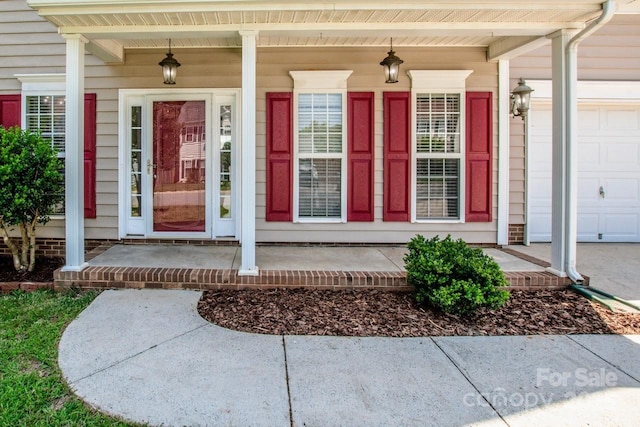 198 Devon Forest Dr, Mooresville, NC 28115 - doorway to property featuring a porch and an attached garage