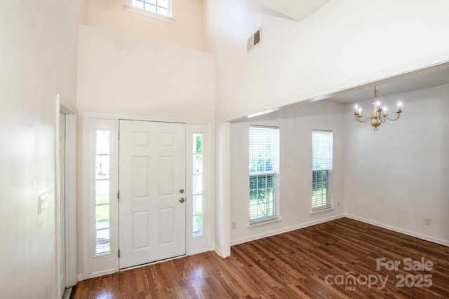 198 Devon Forest Dr, Mooresville, NC 28115 - foyer featuring a chandelier, wood finished floors, and a towering ceiling