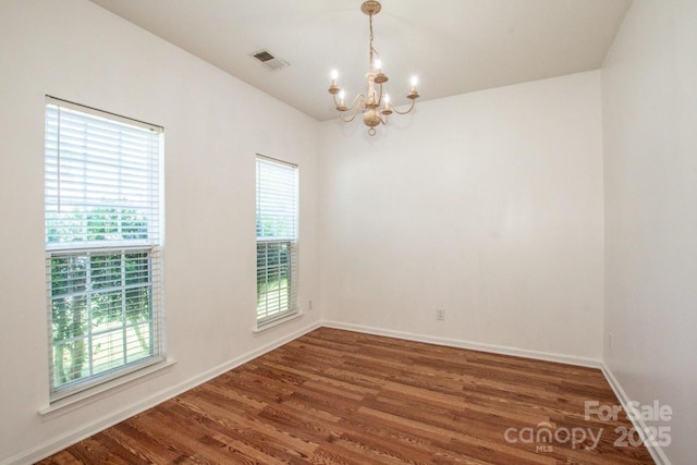 198 Devon Forest Dr, Mooresville, NC 28115 - unfurnished room with a chandelier, wood finished floors, and vaulted ceiling