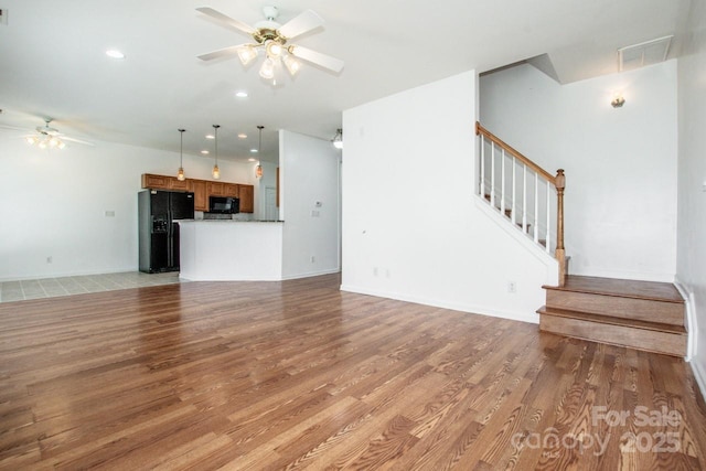 198 Devon Forest Dr, Mooresville, NC 28115 - unfurnished living room featuring ceiling fan, stairs, light wood-type flooring, and recessed lighting