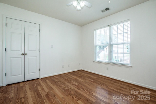 198 Devon Forest Dr, Mooresville, NC 28115 - unfurnished bedroom with wood finished floors, ceiling fan, and a closet
