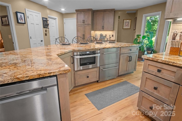 270 Foxwood Dr, Tryon, NC 28782 - kitchen featuring light wood-type flooring, stainless steel appliances, backsplash, light stone countertops, and recessed lighting