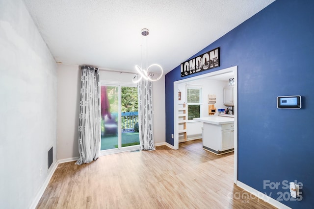 2116 Bon Villa Way, Fort Mill, SC 29708 - dining space with light wood-style floors, vaulted ceiling, and a textured ceiling