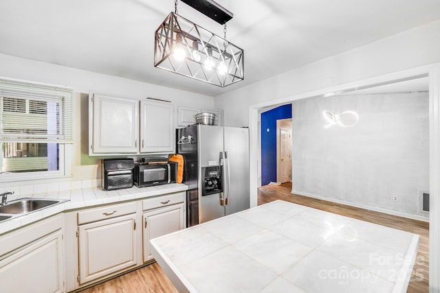2116 Bon Villa Way, Fort Mill, SC 29708 - kitchen featuring stainless steel fridge with ice dispenser, tile countertops, light wood-style flooring, and a chandelier