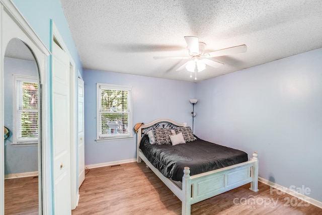 2116 Bon Villa Way, Fort Mill, SC 29708 - bedroom featuring wood finished floors, a textured ceiling, ceiling fan, and arched walkways