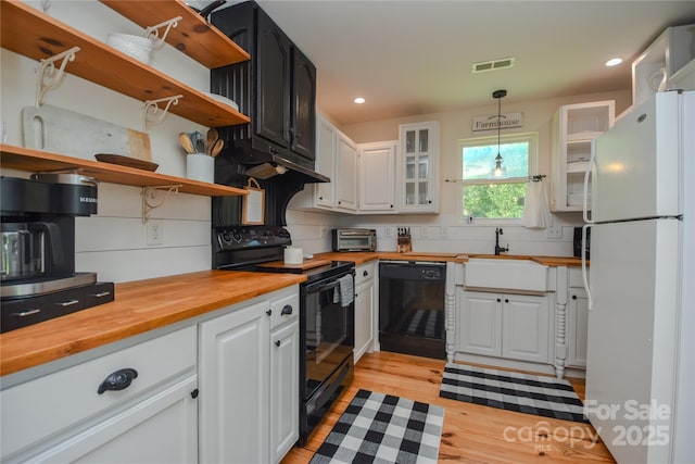 1239 Mac Ln, Stanley, NC 28164 - kitchen featuring black appliances, open shelves, butcher block counters, white cabinetry, and light wood-style flooring