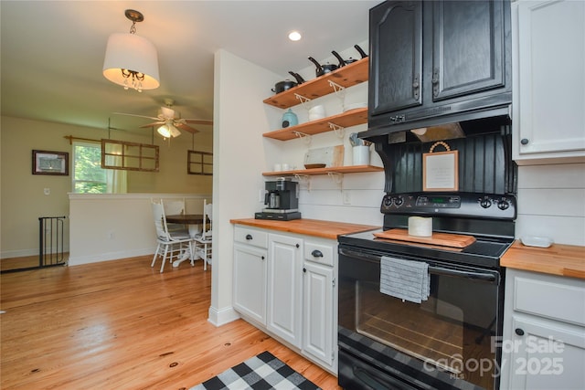 1239 Mac Ln, Stanley, NC 28164 - kitchen featuring black range with electric cooktop, butcher block countertops, ceiling fan, light wood-style floors, and recessed lighting