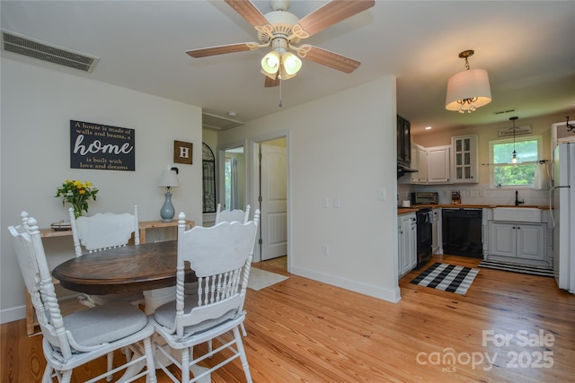 1239 Mac Ln, Stanley, NC 28164 - dining room with light wood-style flooring and a ceiling fan