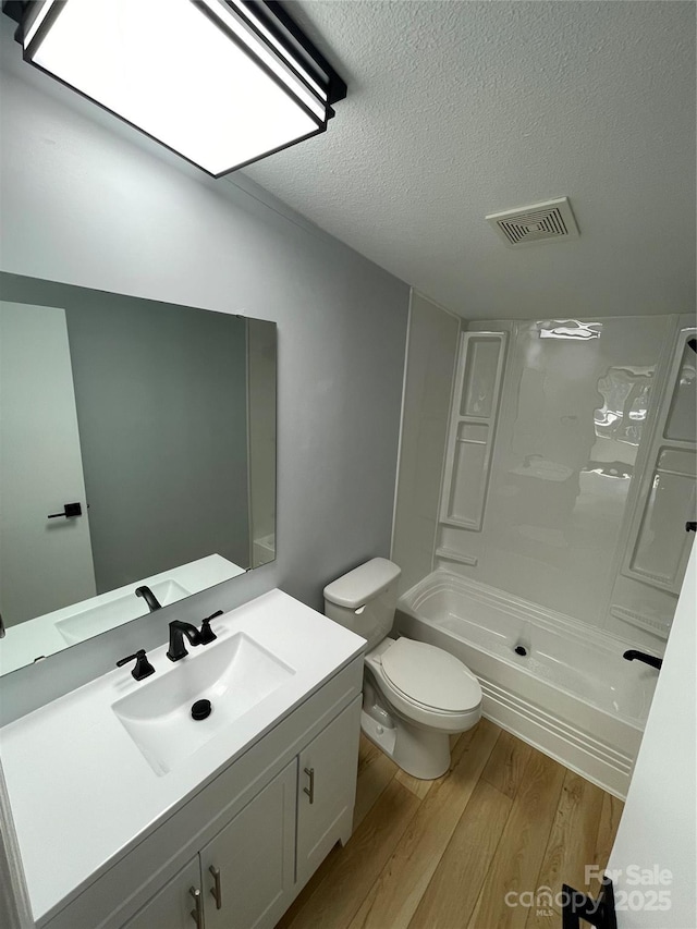 6490 Alta Ctr, Denver, NC 28037 - full bathroom with wood finished floors, vanity, a shower, and a textured ceiling