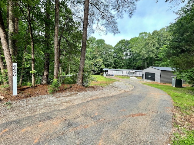 6490 Alta Ctr, Denver, NC 28037 - view of front of house with asphalt driveway, an outbuilding, and a garage