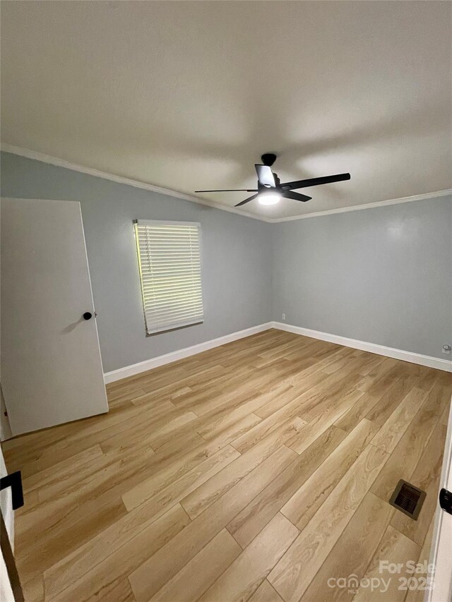 6490 Alta Ctr, Denver, NC 28037 - spare room with wood finished floors, a ceiling fan, and crown molding