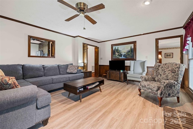 36433 Azalea Cir, New London, NC 28127 - living area with a wainscoted wall, light wood-type flooring, crown molding, and ceiling fan