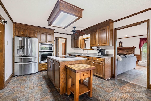 36433 Azalea Cir, New London, NC 28127 - kitchen with appliances with stainless steel finishes, stone tile floors, ornamental molding, ceiling fan, and light countertops