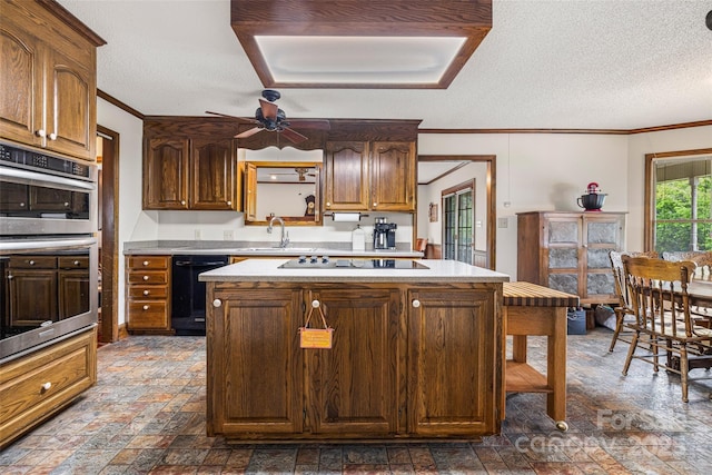 36433 Azalea Cir, New London, NC 28127 - kitchen with black appliances, ornamental molding, a center island, light countertops, and a ceiling fan