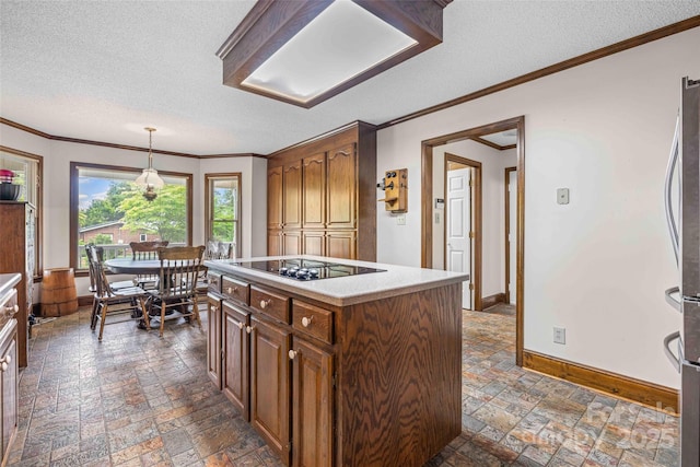 36433 Azalea Cir, New London, NC 28127 - kitchen with black electric stovetop, a textured ceiling, stone tile floors, light countertops, and freestanding refrigerator