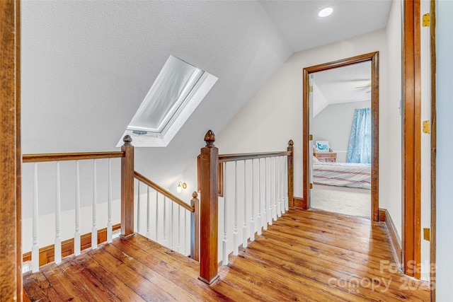 36433 Azalea Cir, New London, NC 28127 - stairway featuring hardwood / wood-style floors, a skylight, and lofted ceiling