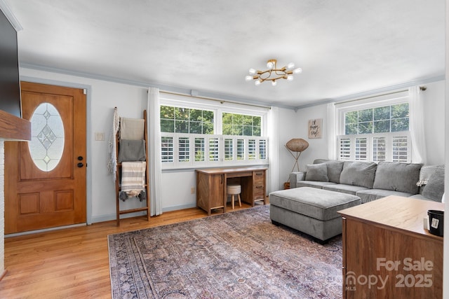 2623 NE 13th St NE, Hickory, NC 28601 - living room with light wood-style flooring, crown molding, and a chandelier