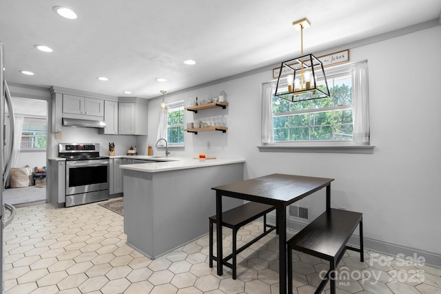 2623 NE 13th St NE, Hickory, NC 28601 - kitchen with stainless steel range with electric stovetop, gray cabinets, under cabinet range hood, recessed lighting, and a peninsula