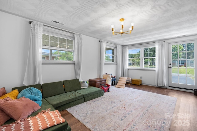 2623 NE 13th St NE, Hickory, NC 28601 - living area featuring a chandelier, wood finished floors, and healthy amount of natural light