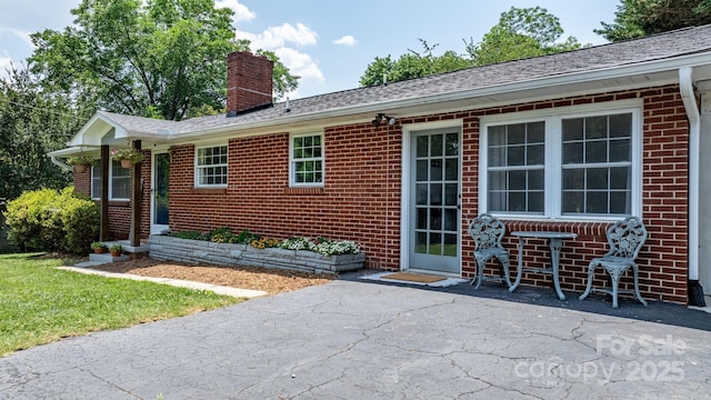 2623 NE 13th St NE, Hickory, NC 28601 - rear view of house with brick siding, a chimney, and a patio