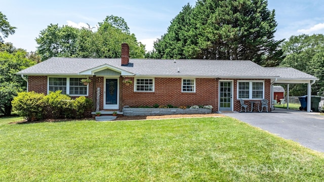 2623 NE 13th St NE, Hickory, NC 28601 - ranch-style house featuring asphalt driveway, a carport, brick siding, and a front lawn