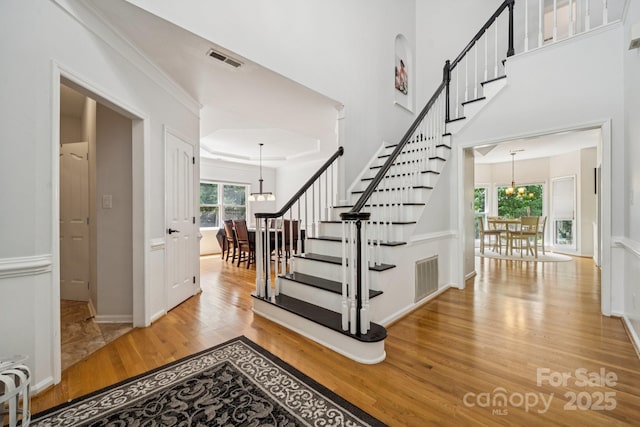4716 Heatherton Pl, Charlotte, NC 28270 - foyer featuring a chandelier, wood finished floors, and stairway