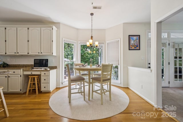 4716 Heatherton Pl, Charlotte, NC 28270 - dining space with a chandelier and light wood-style floors