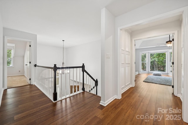 4716 Heatherton Pl, Charlotte, NC 28270 - hallway with an upstairs landing, hardwood / wood-style floors, and a chandelier