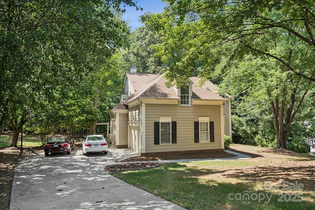 4716 Heatherton Pl, Charlotte, NC 28270 - view of front of house featuring a chimney, driveway, and roof with shingles