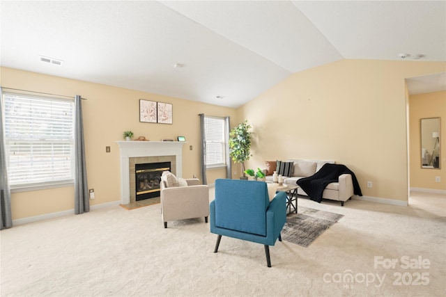 7616 Shiny Meadow Ln, Charlotte, NC 28215 - living area with vaulted ceiling, carpet flooring, plenty of natural light, and a tiled fireplace