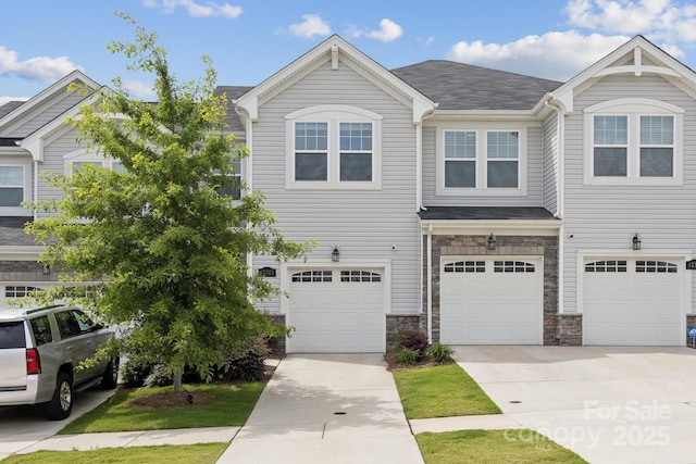 13323 Savaine St, Charlotte, NC 28278 - view of front facade with driveway, an attached garage, stone siding, and a shingled roof