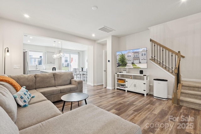 13323 Savaine St, Charlotte, NC 28278 - living room featuring wood finished floors, stairs, and recessed lighting