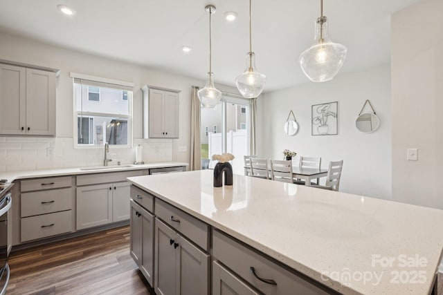 13323 Savaine St, Charlotte, NC 28278 - kitchen with gray cabinets, backsplash, healthy amount of natural light, dark wood finished floors, and recessed lighting