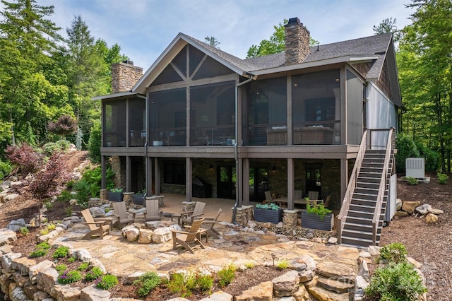 2101 October Dr Unit 150, Nebo, NC 28761 - rear view of house with a chimney, a sunroom, a fire pit, and a patio