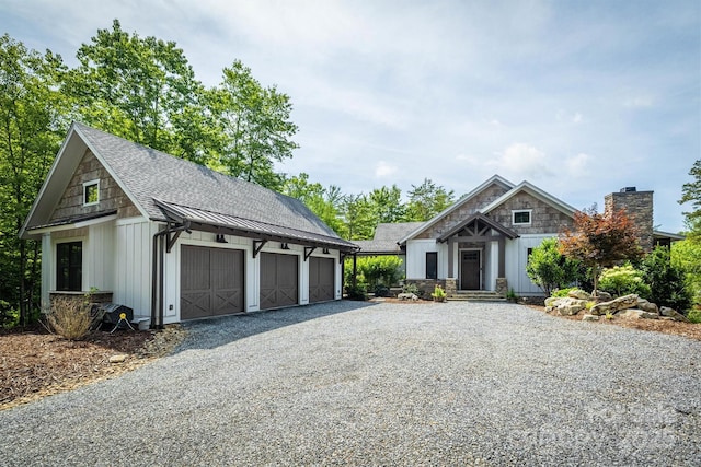 2101 October Dr Unit 150, Nebo, NC 28761 - view of front facade with a standing seam roof, board and batten siding, an outbuilding, a metal roof, and a garage