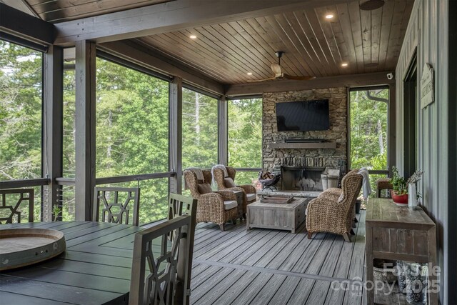 2101 October Dr Unit 150, Nebo, NC 28761 - sunroom / solarium featuring a fireplace, ceiling fan, and healthy amount of natural light