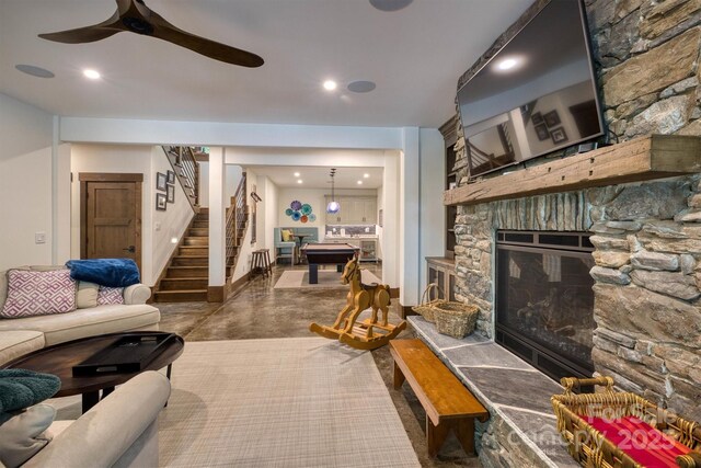 2101 October Dr Unit 150, Nebo, NC 28761 - living area featuring stairs, concrete flooring, a ceiling fan, a stone fireplace, and recessed lighting