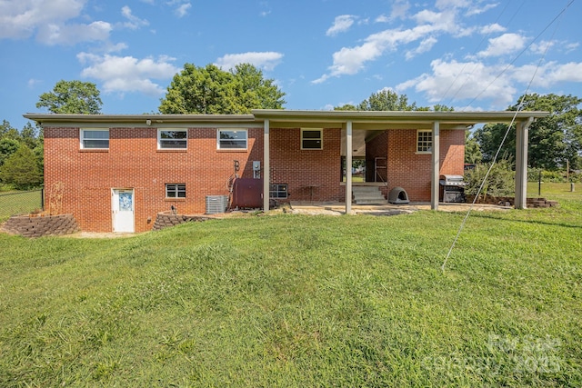 164 Dogtrot Rd, Mocksville, NC 27028 - rear view of house with a lawn and brick siding